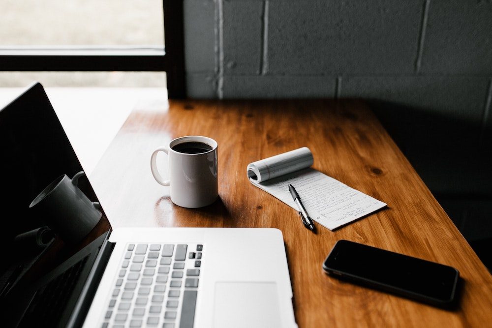 Adding value - Laptop and notepad - Photo by Andrew Neel on Unsplash