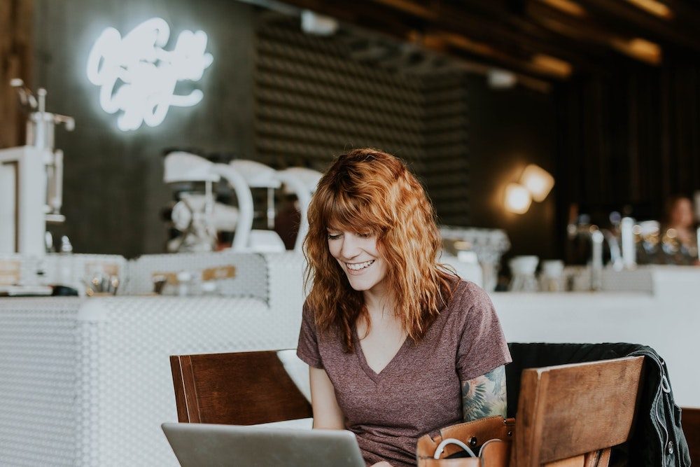 Woman working at a cafe - Photo by Brooke Cagle on Unsplash